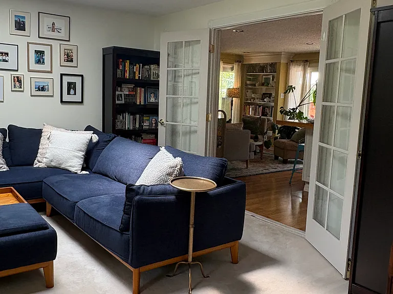 Living room with french door leading to kitchen and family room