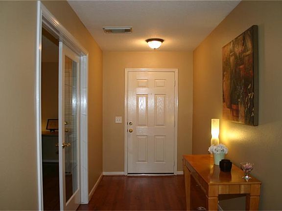 Front entry view. Hardwood laminate floors with over-sized study to the left.