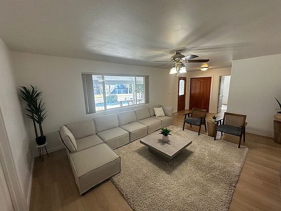 Spacious living room with abundant natural light and open seating area.
