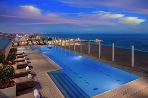 Rooftop pool at sunset with view of Santa Monica pier - 1221 Ocean Avenue