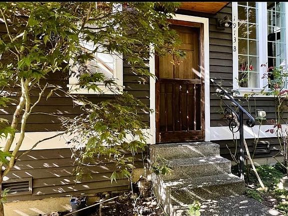 front door with wood screen door