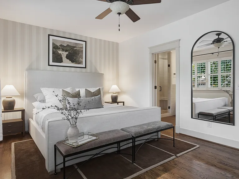 The primary suite features a king-sized bed, huge walk-in closet, ceiling fan, dresser, smart TV, and ensuite bathroom.