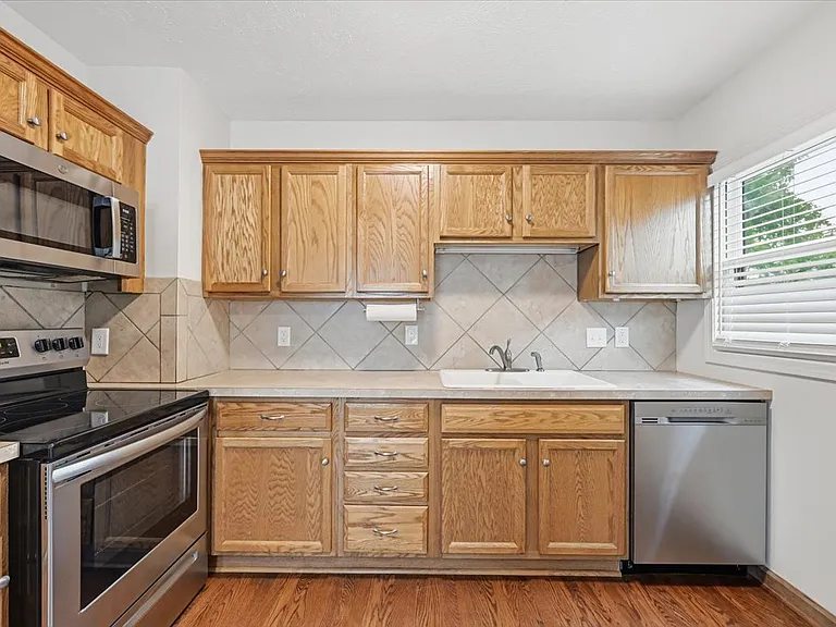 Stainless steel dishwasher, range, and microwave.