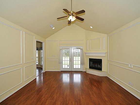 This is nice sized family room with a corner fireplace, and french doors to the back porch