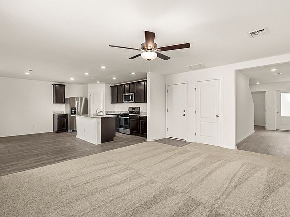 Never miss a beat with the kitchen overlooking the dining area and family room.