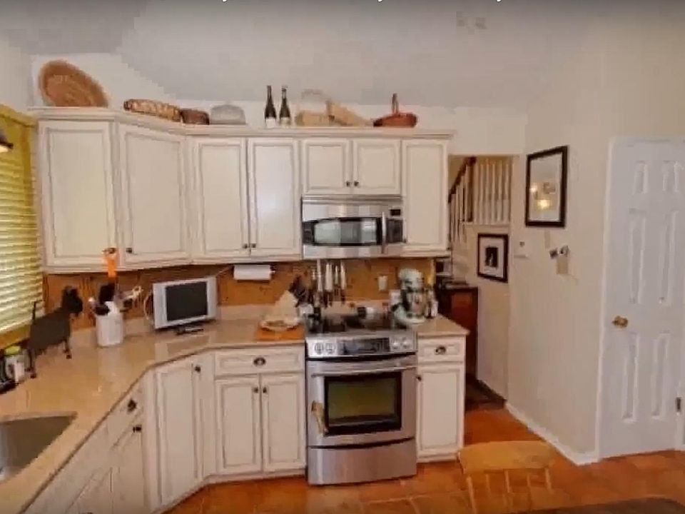 Kitchen with storage shelves and large pantry on the right. All appliances included (microwave, electric stove, dishwasher, refrigerator, washer and dryer)