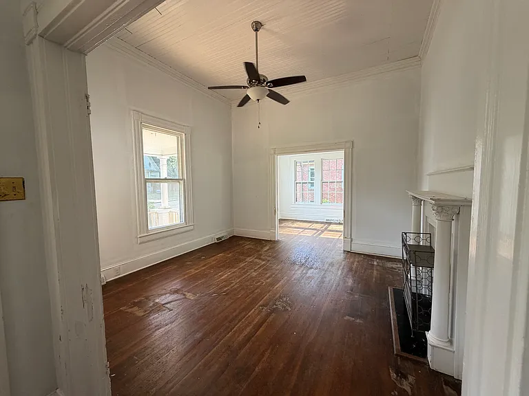 Large Den with vaulted ceilings with adjoining sun room.