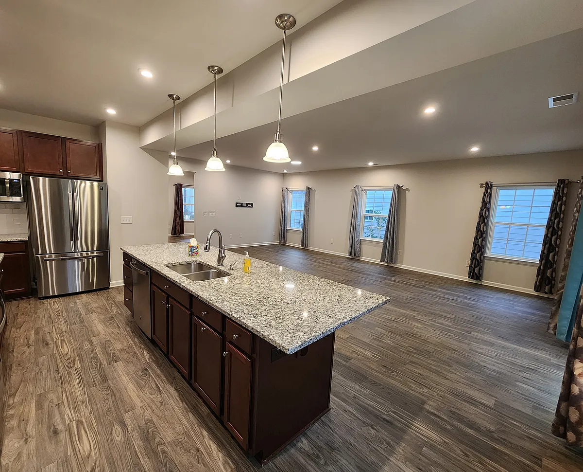 Heart of the Home - Chef-inspired kitchen featuring gleaming granite countertops and a seamless view into the light-filled living and dining areas_perfect for modern, open-concept living. - 162 Tawny Slope Ct