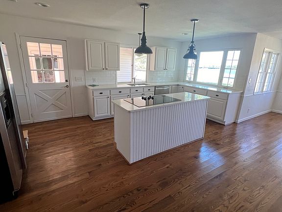 Open kitchen plan with a wood burning fireplace. Views of the lake from the kitchen