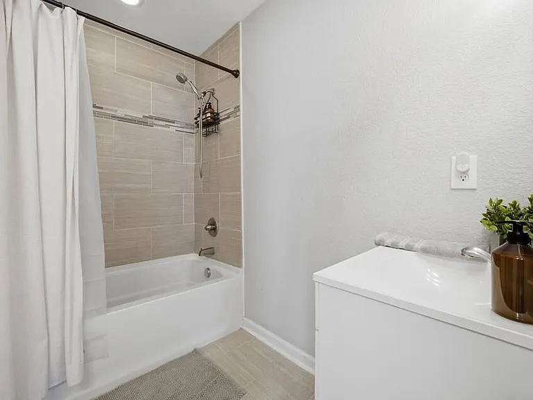 Primary en-suite bathroom with 2 vanity sinks.