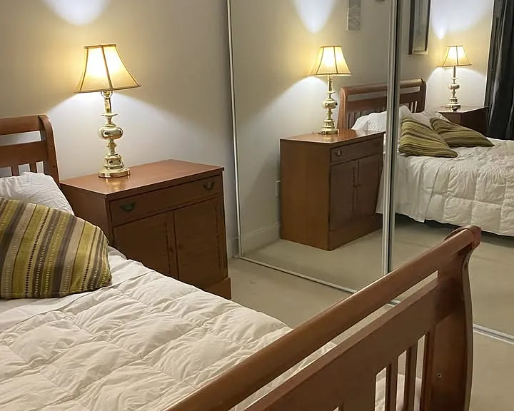 Bedroom with mirrored closet doors