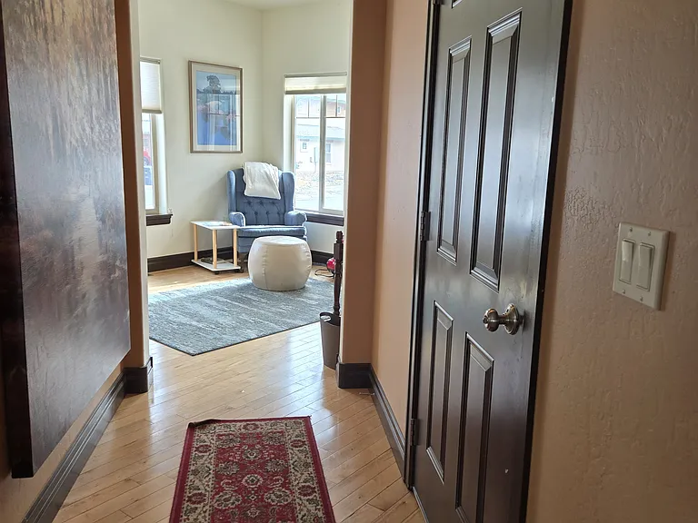 Door to/from two car garage. Opens to the front room on one side, and kitchen, DR and LR on the other