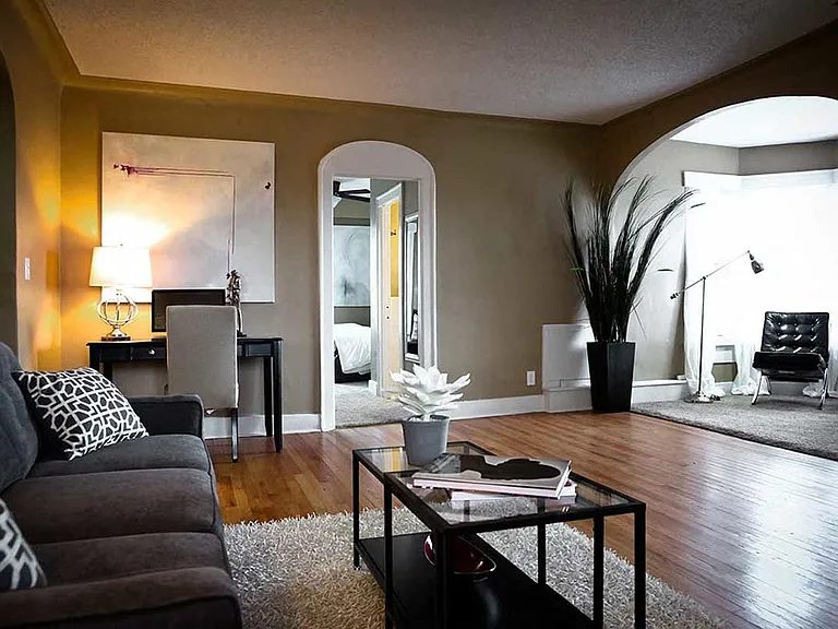 Furnished living room with arched details.