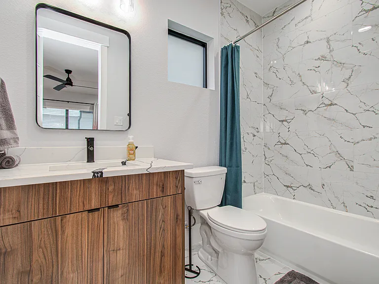 Private bathroom conveniently located next to the third bedroom, providing comfort and privacy for guests.