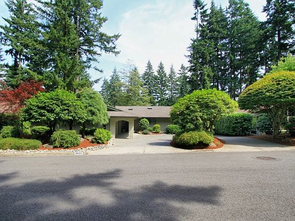 The gardens in front of this home reflect the professional design created for low maintenance and feature Pacific Northwest favorites. The 40-year old rhododendron trees blossom in springtime with rich pink flowers and the diverse collection of Japanese and Lace-leaf Maple trees in the lush gardens display the thoughtful selection and planning.