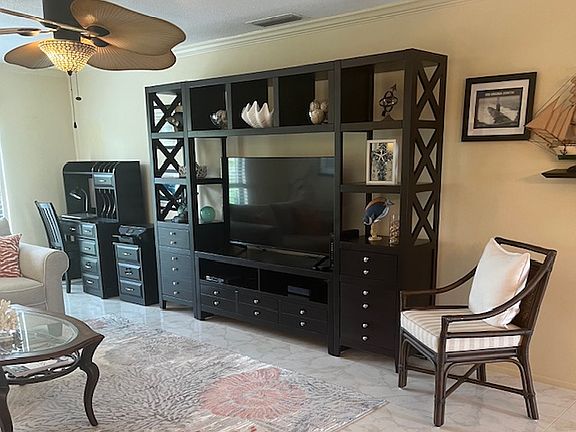 Entertainment center in family room with designated office area.