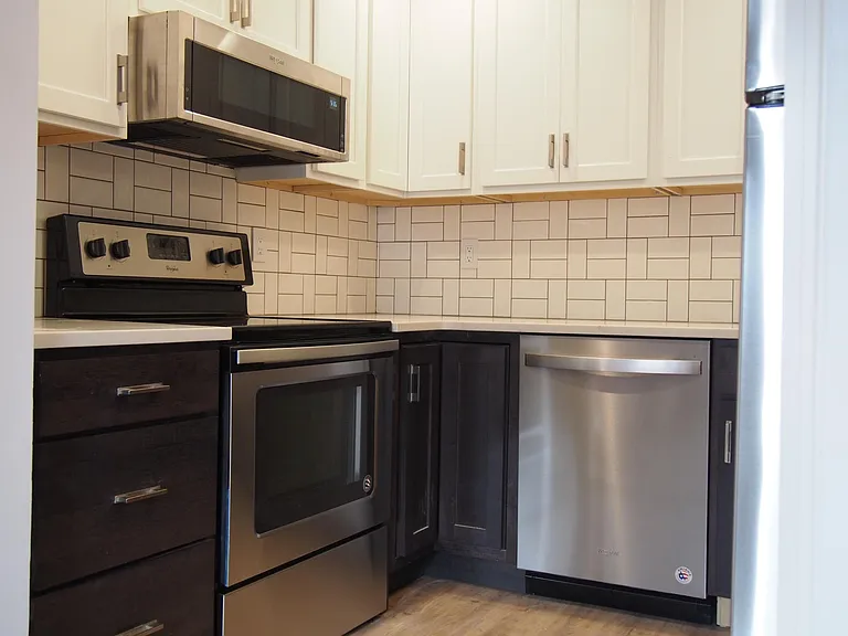 Kitchen - Tons of new cabinets, stainless appliances, garbag