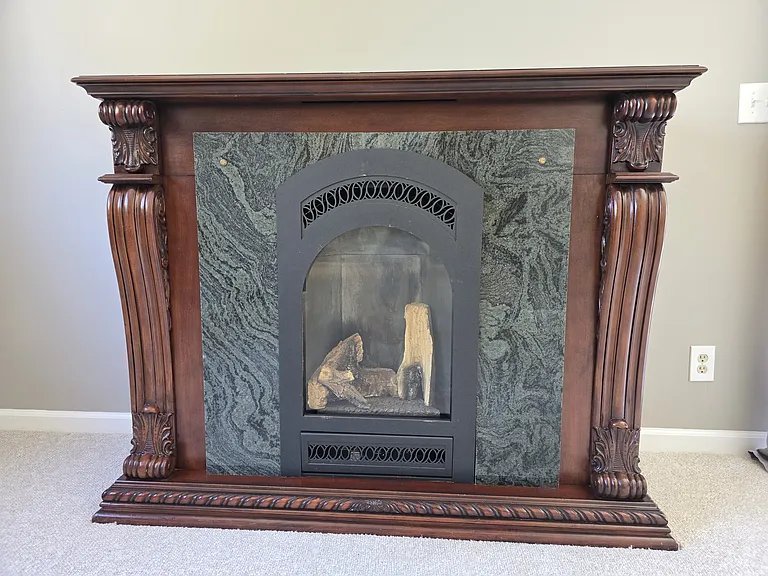 Beautiful propane gas fireplace is on thermostat for easy heating. This is the main heat source for this space.