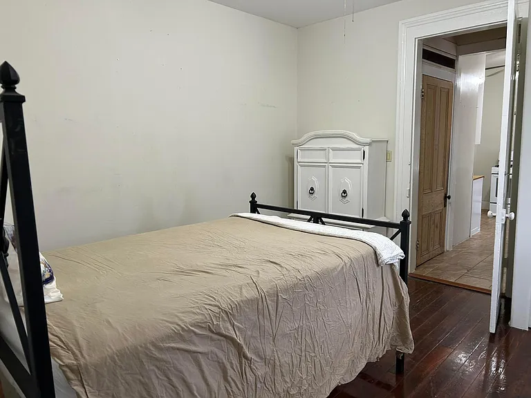 Bed and dresser, natural cypress wood bathroom door right of pic