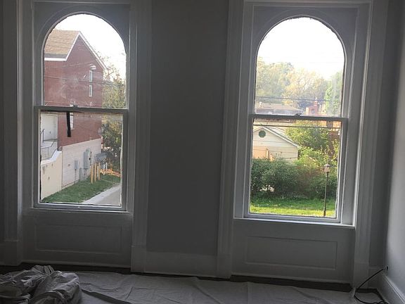 arched windows in 1st floor bedroom.