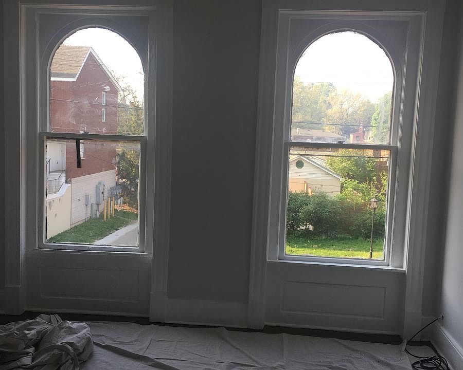 arched windows in 1st floor bedroom.
