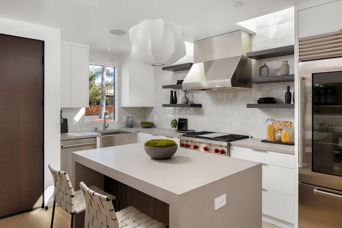 Chef's kitchen! Wolf oven/convection with 4 burners and griddle. Subzero restaurant quality fridge, wine fridge, microwave drawer, tons of storage, Caesarstone counter tops. Custom Zia tile Zellige back splash.