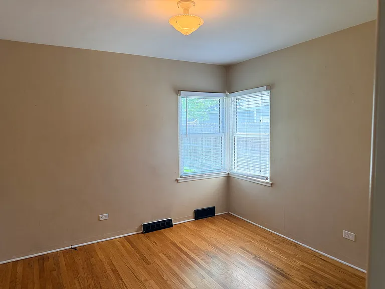 1 spacious bedroom with hardwood floors and windows looking out over your own private, fenced backyard.
