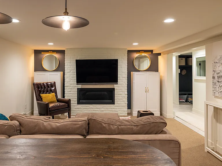 Basement living space features a beautiful gas fireplace.