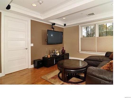 Living room with custom TV mount and built wired surround sound.