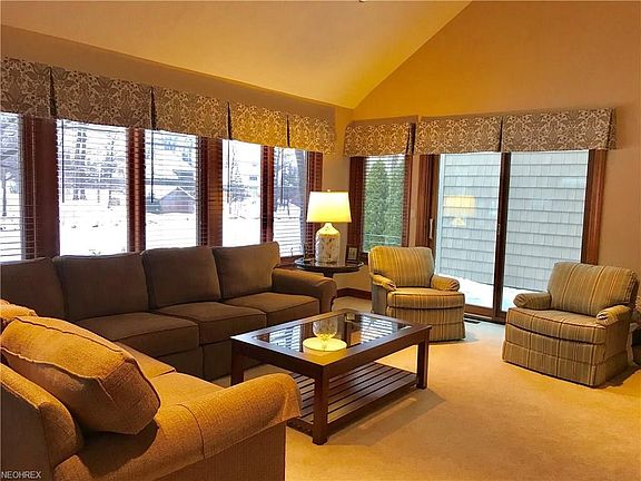 Spacious, vaulted ceiling, great room with double set of sliding doors on each side and the whole rear is windows overlooking a pond and the golf course.