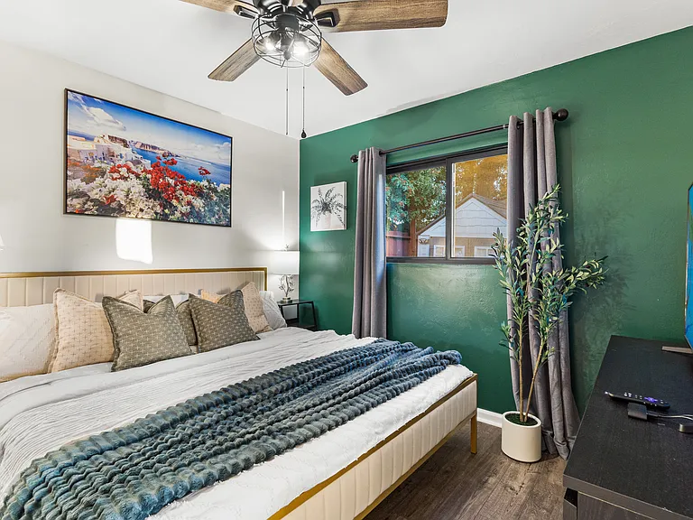 A cozy bedroom featuring a TV for ultimate relaxation and entertainment!