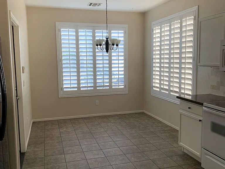 Dedicated dining area with beautiful window shutters.