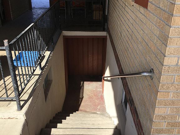 Stairs to apartment on the right, basement on the left