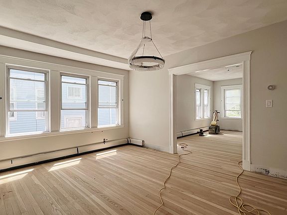 Large dining room with beautiful hardwood flooring.