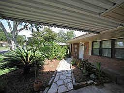Front Walkway - carport and deep eaves provide protection from the elements when entering, flagstone