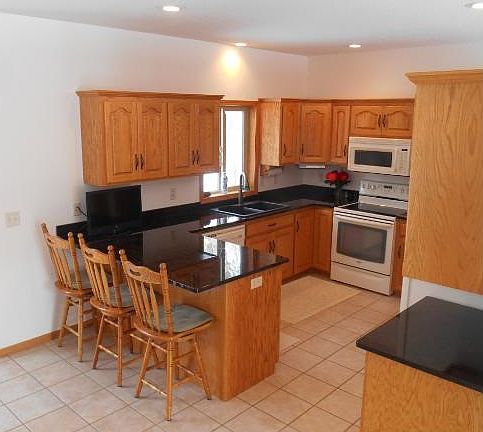 Spacious kitchen just installed a new granite sink.