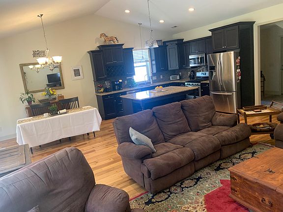 Shared space includes kitchen with natural gas stove, huge granite island, large stainless double sink, lots of cabinet space! New dining room table with upolstered chairs (not in pic.)