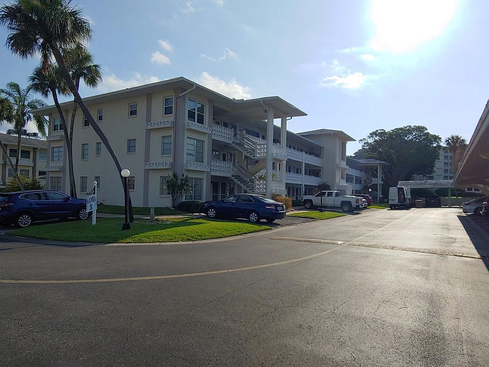 Building 2. Carport with assigned parking space is on the right. (Additional uncovered parking available).