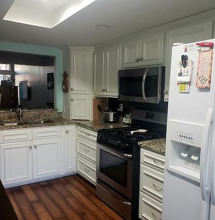 Kitchen open to bar, dining and living rooms