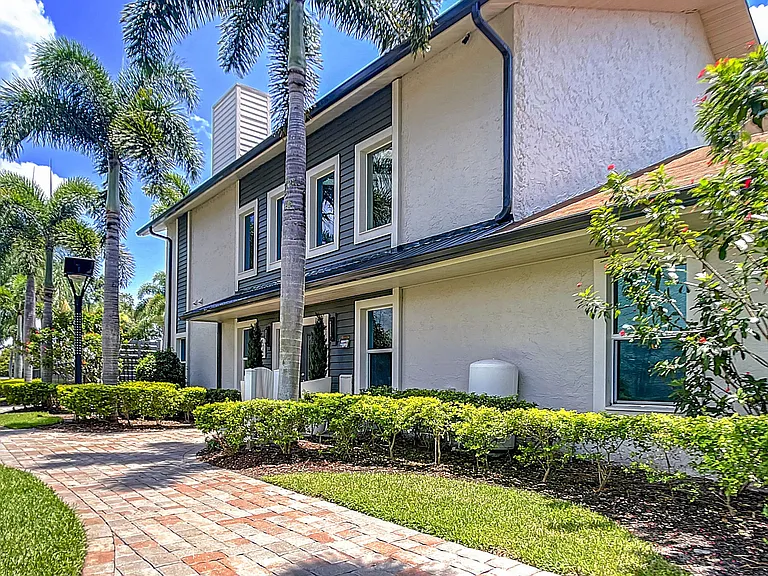 Discover the serene beauty of our apartment community, nestled amidst lush greenery and towering palm trees!