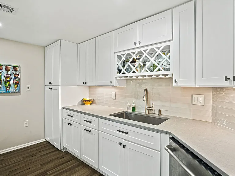 Gourmet galley kitchen featuring an expansive pantry, premium motion-sensor faucet, deep basin sink, and generous counter space for all your culinary needs