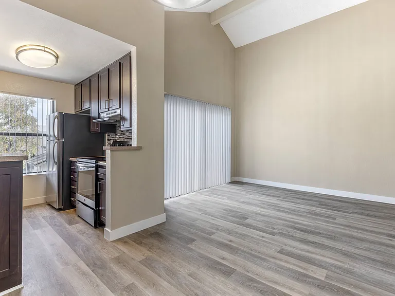 njoy the seamless flow of this stunning apartment, where a fully-equipped kitchen with sleek stainless steel appliances effortlessly connects to the dining room and expansive living space.