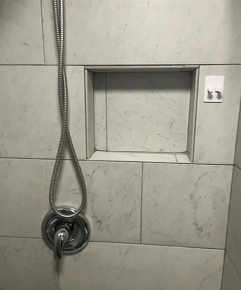 Another cubby for storing shower items along with a hook for razor and or wash cloth.