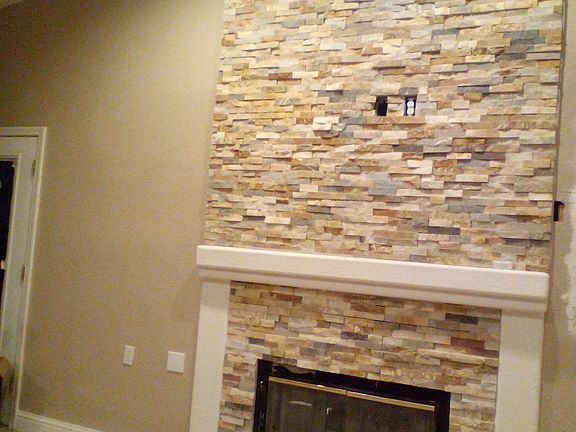 Stone ledger tiled fireplace floor-to-ceiling