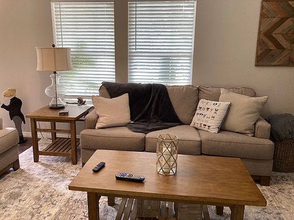 Living Room has Standard and Love seat couches along with side tables and coffee table, VERY spacious room
