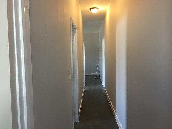 Hallway view from bathroom facing bedrooms and living room.