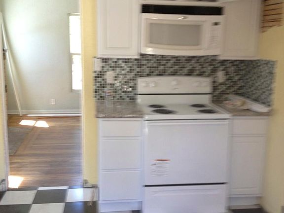 Kitchen w/ electric range and built-in microwave