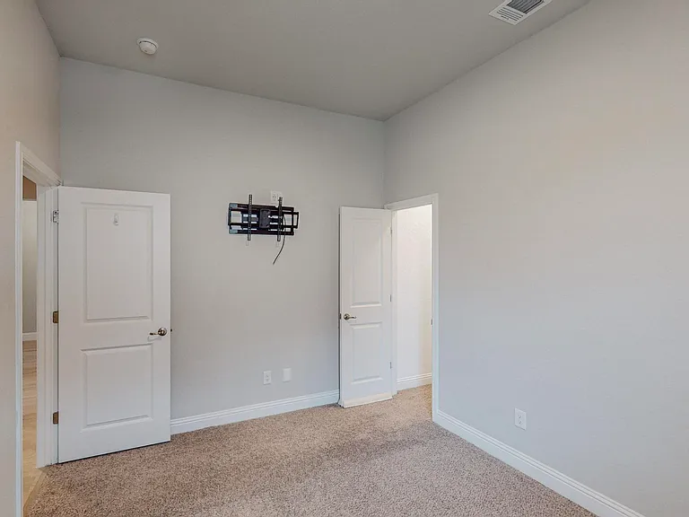 Featuring one of the many walk-in closets throughout the home