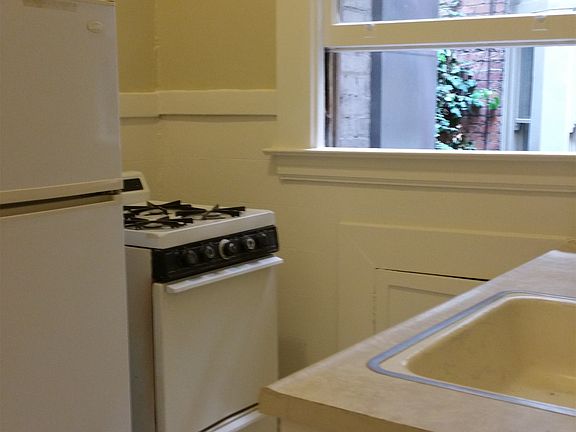 gas stove and window out to building interior