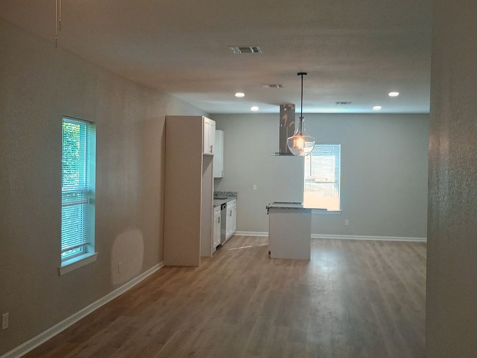 Upstairs unit from Living Room through Dining area to Kitchen. All new laminate wood flooring, new light fixtures, new drywall, new everything!